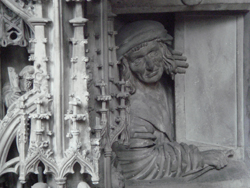 Person peering out of a window under the pulpit of St Stephans Cathedral in Vienna