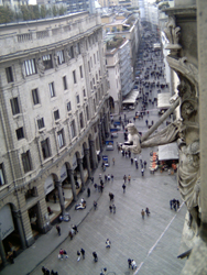 View of street and high-level wall statue from the roof of Milan Duomo