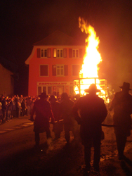 Large bonfire being brought through the Altstadt of Liestal for the Chienbaesen festivities