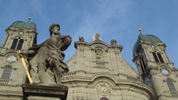 Statue of St Paul in front of the two towers of the Benedictine Einsiedeln Monastry