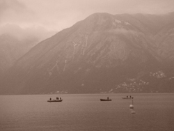 Boats on the misty Lake Lugano, Ticino, Switzerland