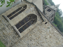 Church window and Romanesque tower of the Abbey of Saint Maurice, the oldest Abbey north of the Alps