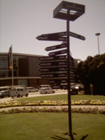 Sign giving distances to many places at Christchurch International Airport